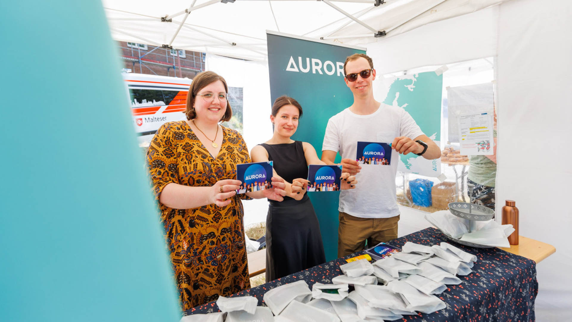 Aurora Vertreter:innen am Duisburger Campus an einem Informationsstand 
