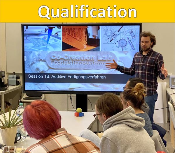 A yellow bar with the heading Qualification. Below it is a picture of a person giving a lecture in front of a group of seated people.