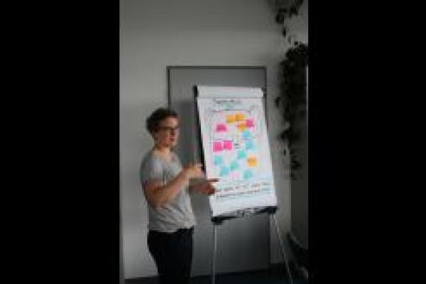 Das Bild zeigt Kathrin Jurgenowski während sie das Gelernte des Workshops auf einem Flipboard zusammenfasst