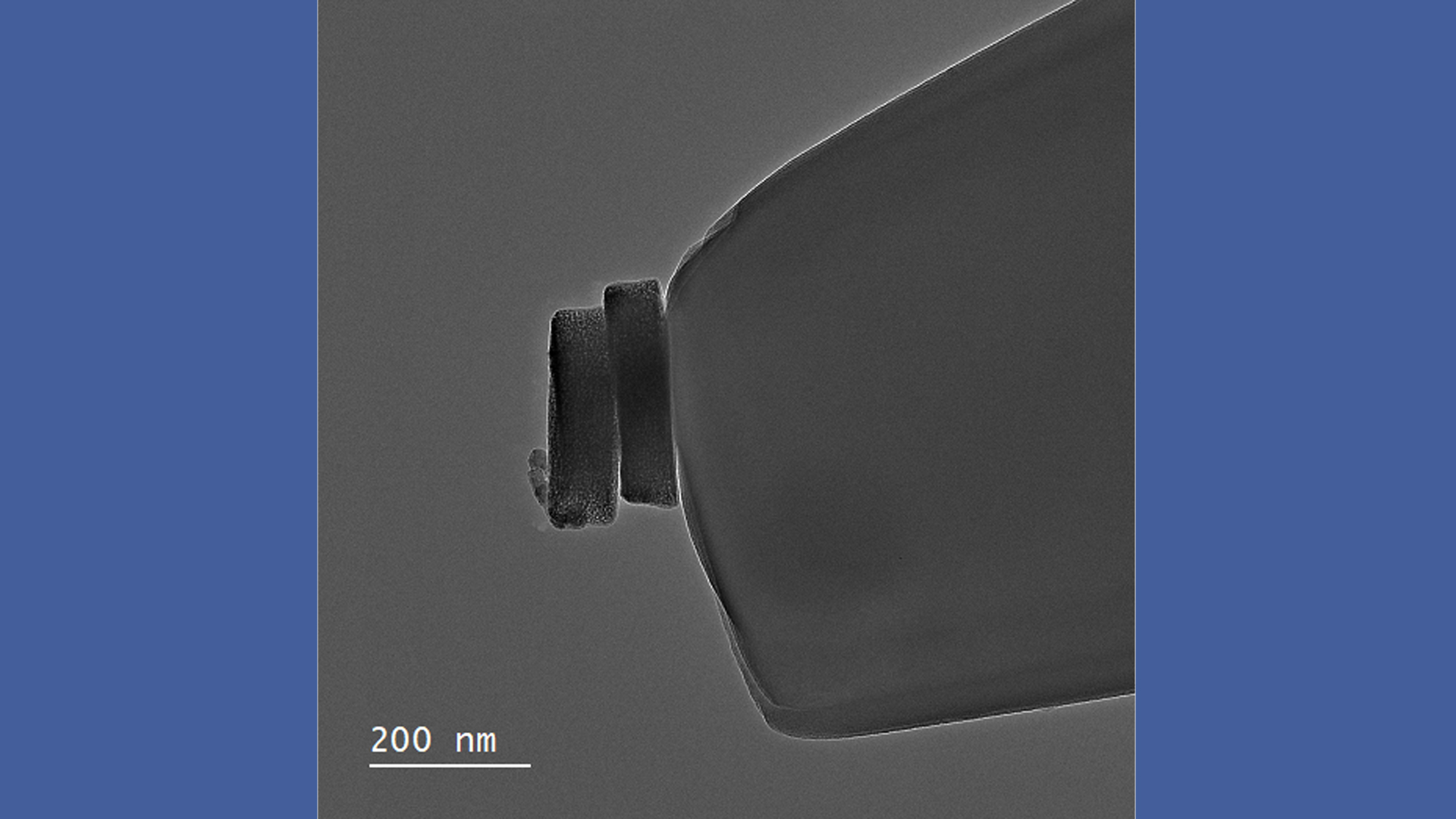 Image taken by electron microscopy: Two tiny particles on an electrode.