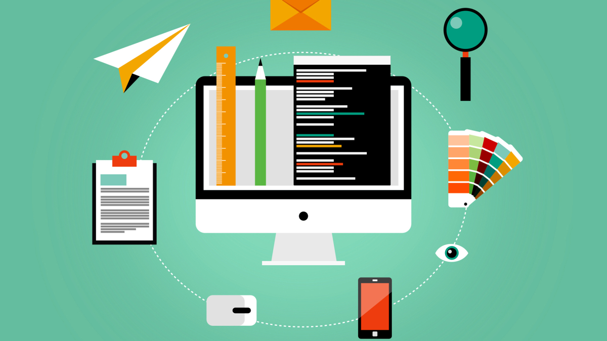 Monitor surrounded by different items like a magnifier or a mobile phone