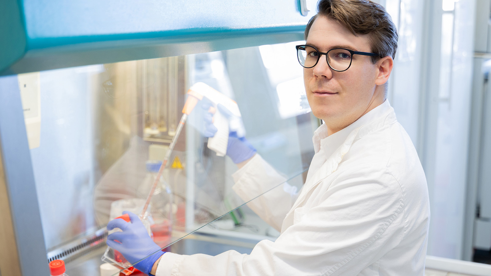 Mike Blueggel sitting at a lab bench.